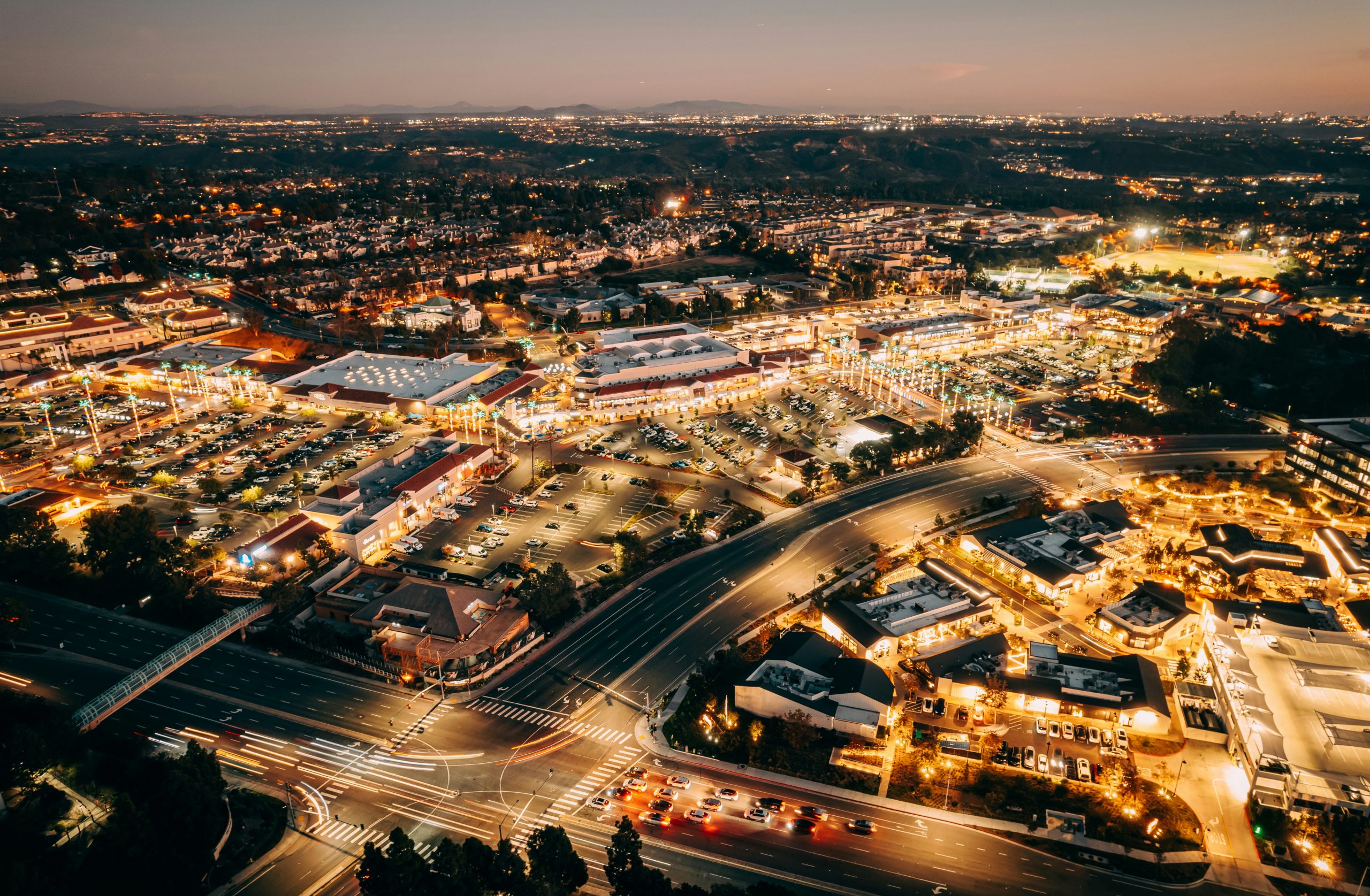 Aerial view of Carmel Valley with shopping centers, business parks, and residential houses at night